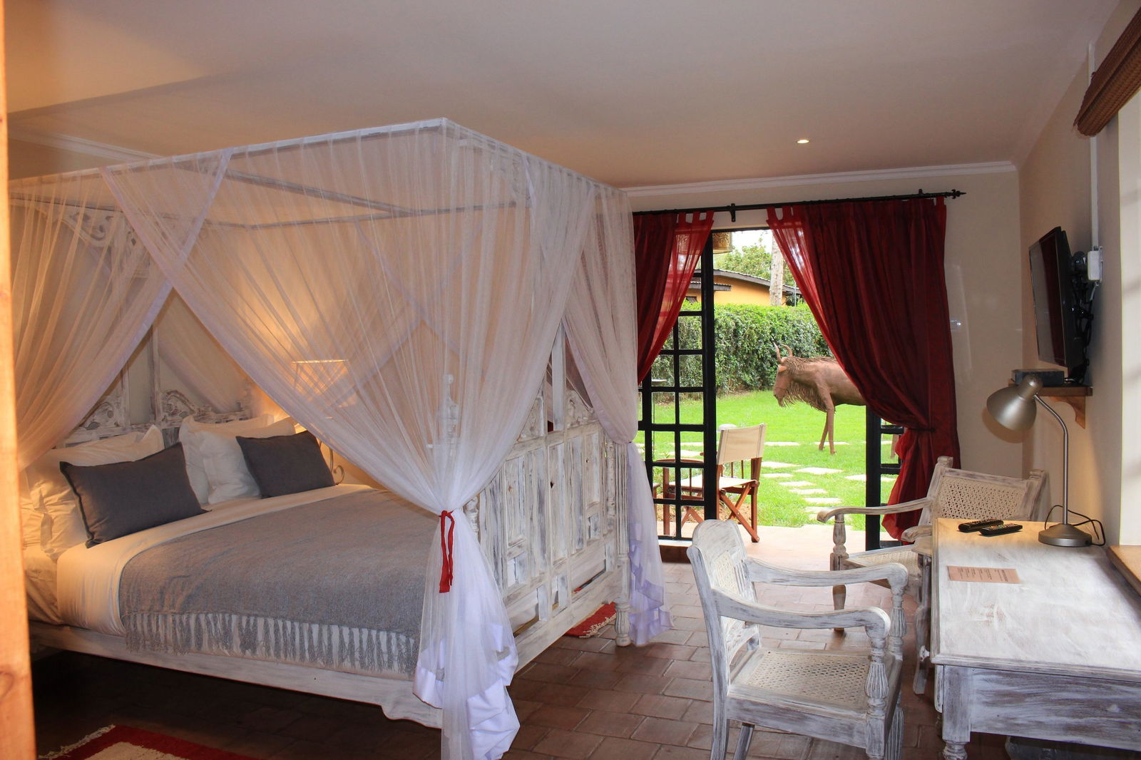 Room setup with views of the yard at Le Rustique Hotel in Nakuru
