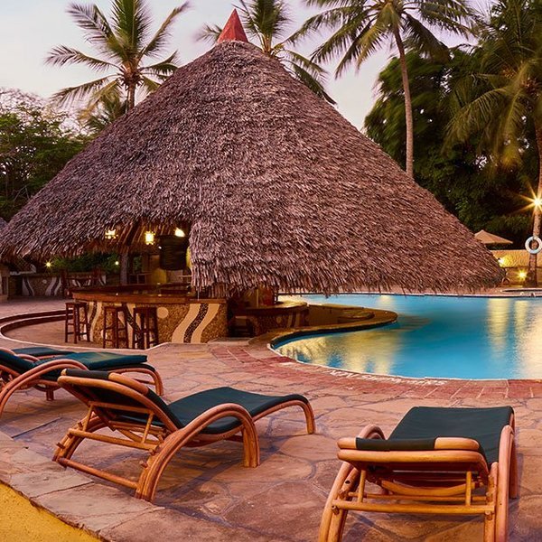 Swimming pool area and bar at Pinewood Beach resort in Kenya