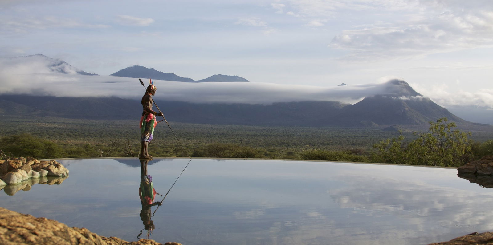 Samburu warrior standing next to Sarara infinity pool in Samburu