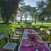 Outside dining setup on the lawns of Olerai House with views of Lake Naivasha