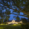 Exterior view of the Manor at Ngorongoro during the night with its expansive lawn