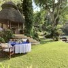The lawn, outside dining setup and exterior view of Mfangano Island Lodge