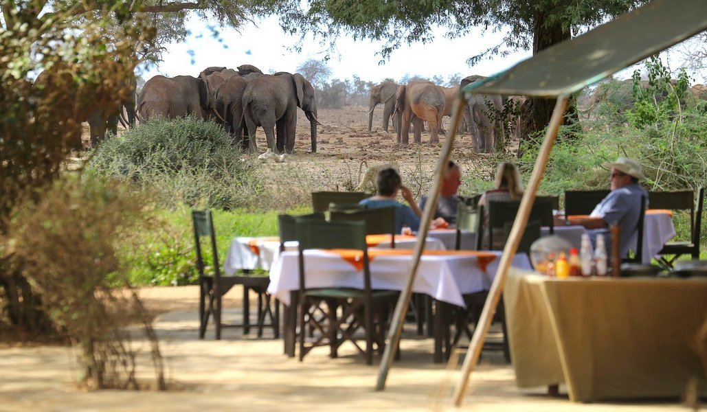 Dining area setup overlooking herds of elephants at Satao Camp in Tsavo