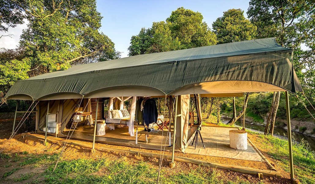 Tent setup by the river in Mara at Emboo River Camp