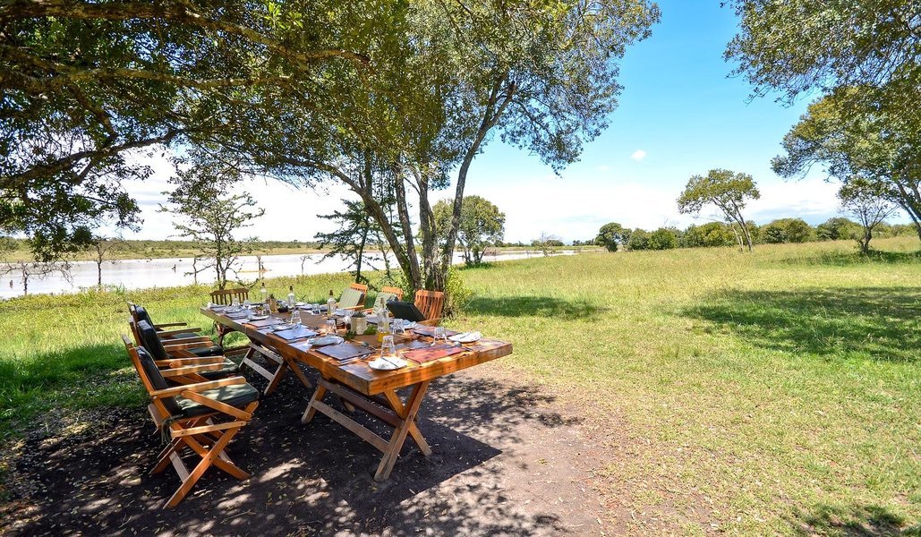 Dining setup by the river at Kicheche Laikipia Camp