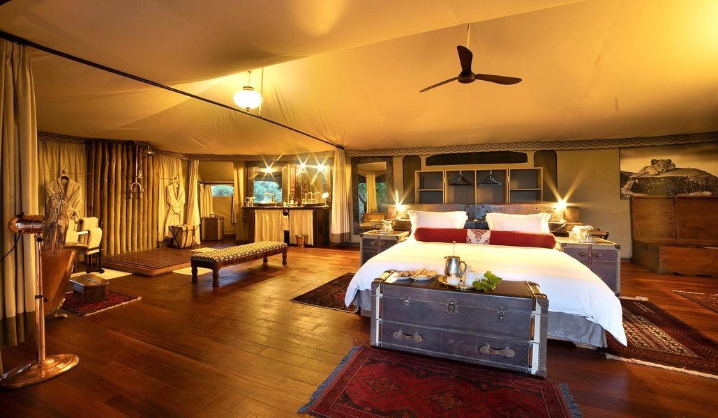 Bed set up inside their large tents at Mara Plains Camp