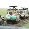 A cheetah on top of safari vehicle in Tanzania