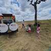 A family setting up a picnic lunch spot in the mara