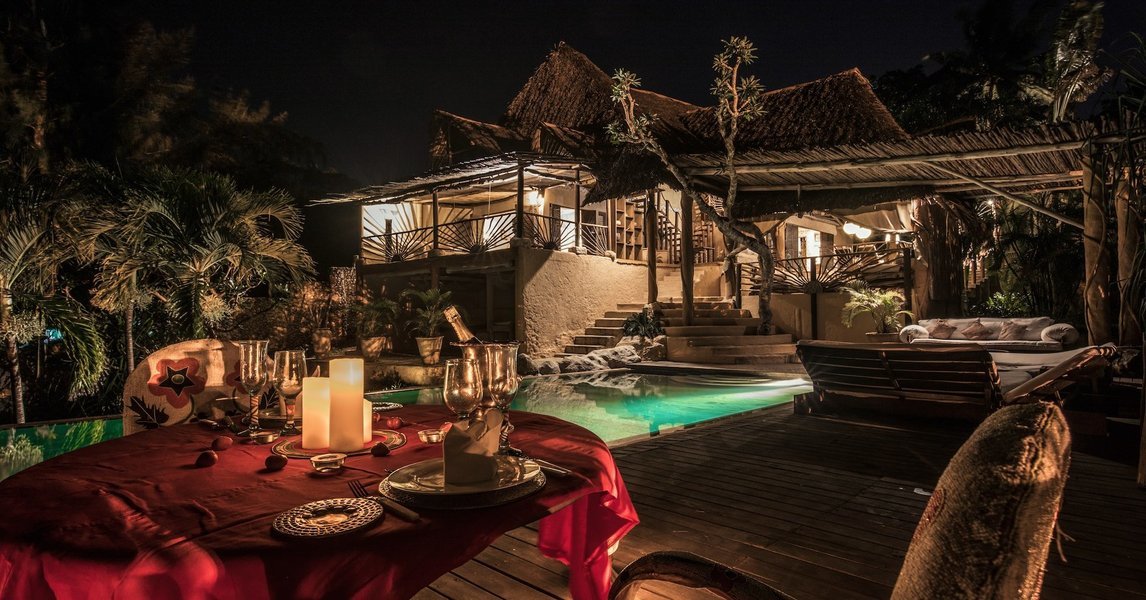Swimming pool area and private dining setup at Alfajiri Beach Villa