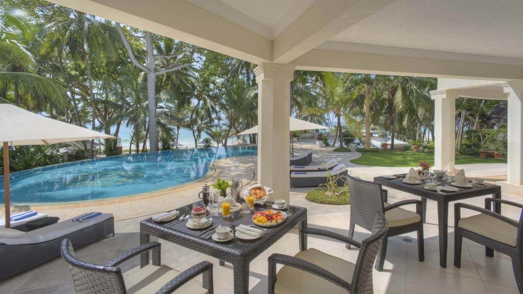 Dining area by the swimming pool at Almanara Luxury Reort