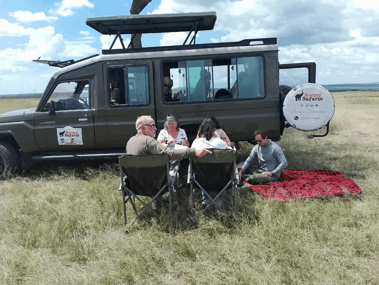 Travellers taking picnic lunch while on our 10 days Kenya and Tanzania Safari