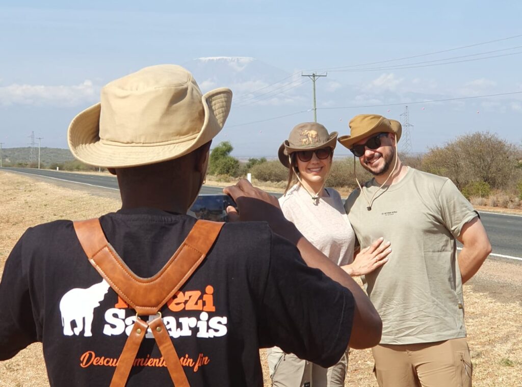 A couple taking picture with Mt Kilimanjaro as the backdrop