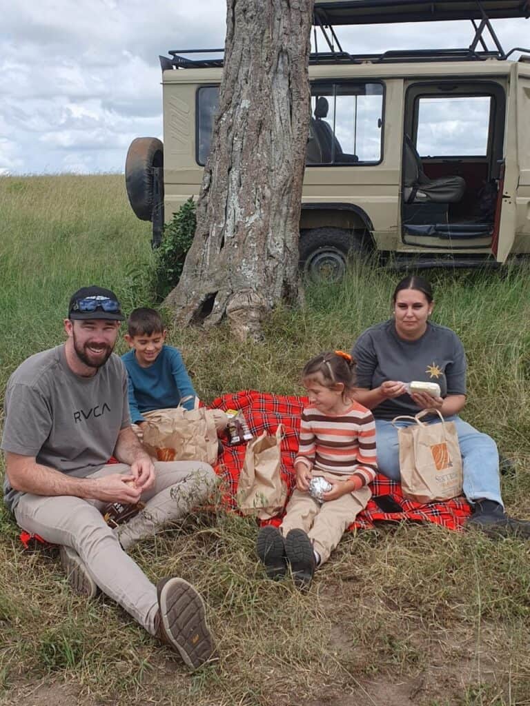 Family having a picnic lunch in Masai Mara