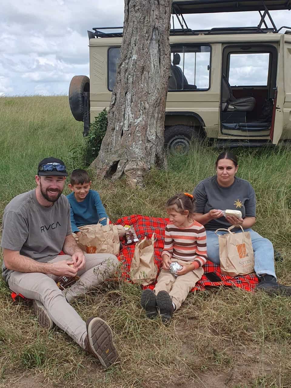 Family having a picnic lunch in Masai Mara
